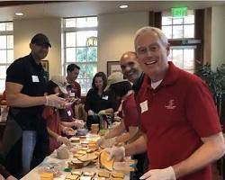 Alumni for Others packing meals for the homeless.