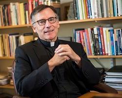 Fr. O'Brien seated in his office.