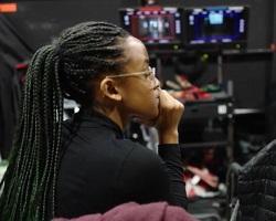 Profile of woman in a TV studio.