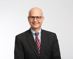 Headshot of a man in glasses.