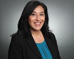 Portrait of a woman with dark hair.