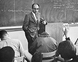 A younger Mario Belotti teaching in the classroom.