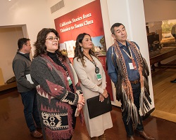 Two women and a man standing in a history museum.