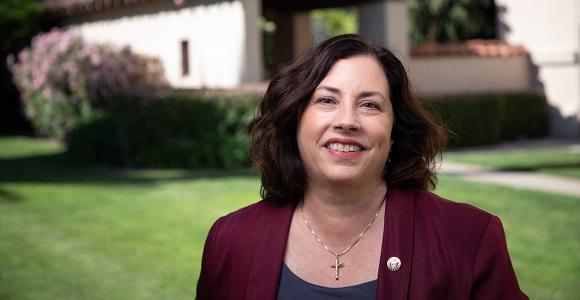 Woman in a maroon blazer.