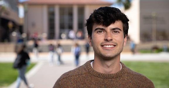 Portrait of a man in a brown sweater.