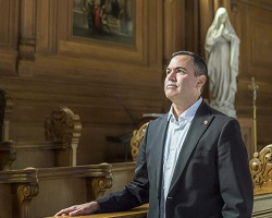Man standing in a Catholic church.