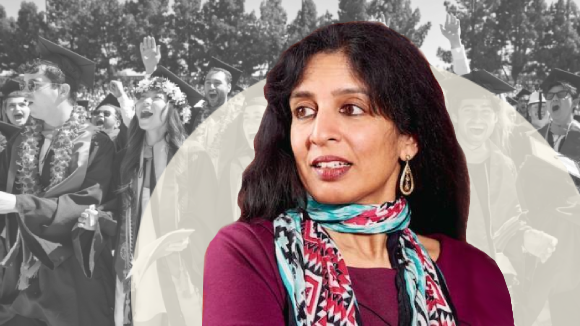 A woman of Indian descent looking to her right with a neutral expression. Behind her is a grayscale image of happy, smiling graduates in their caps and gowns.