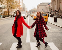Two young women crossing the street.