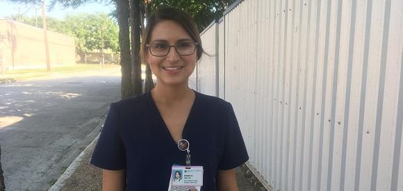 Alumna Sonia Suri in scrubs.