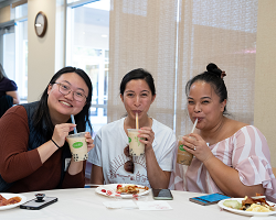 Three women drinking Boba tea.