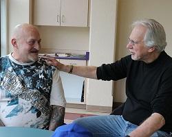 Two men sitting together.