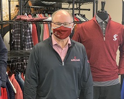 Man wearing Santa Clara face covering. 