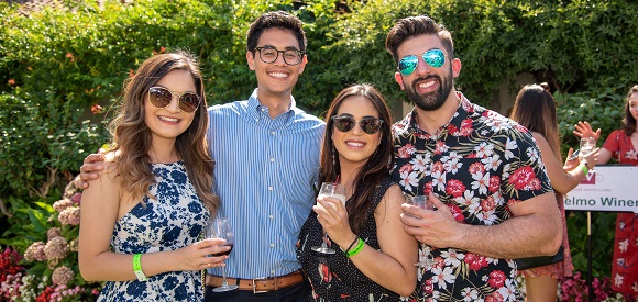 Four adults posing for a photo.