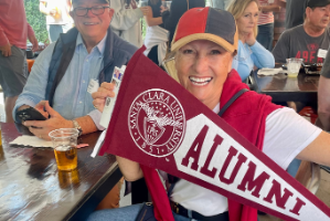 Alumni holding alumni banner