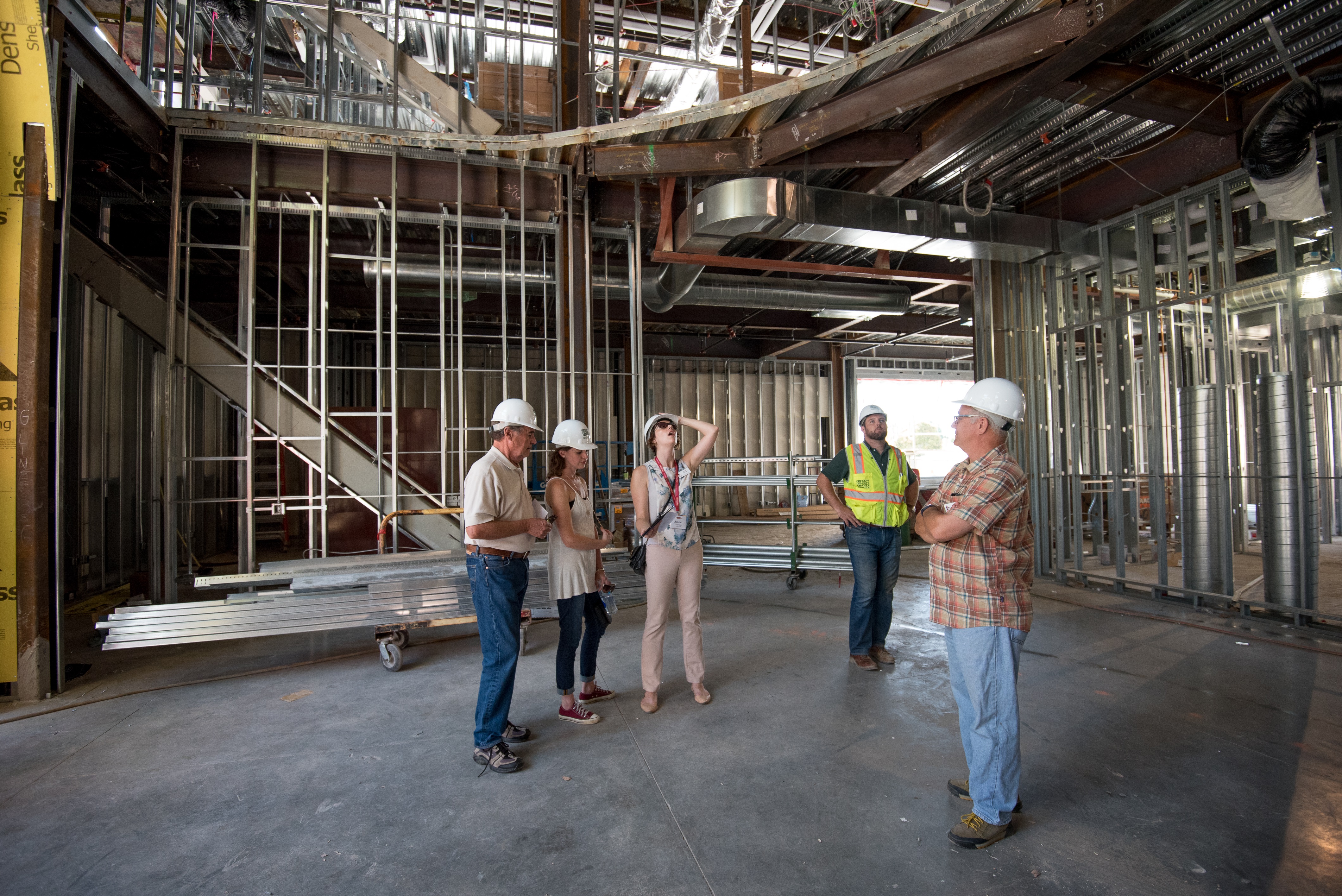 A group of workers inside a building under construction.
