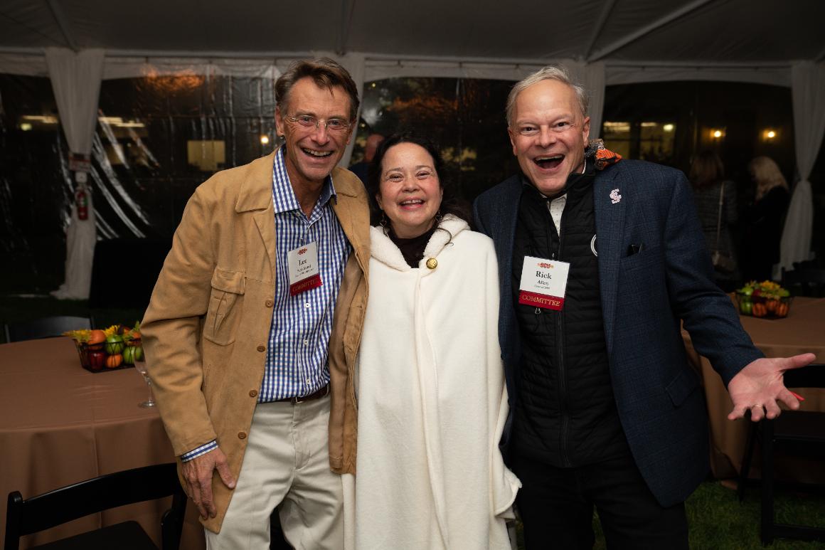 Two men and a woman laughing at the camera at Santa Clara Universitys Grand Reunion.