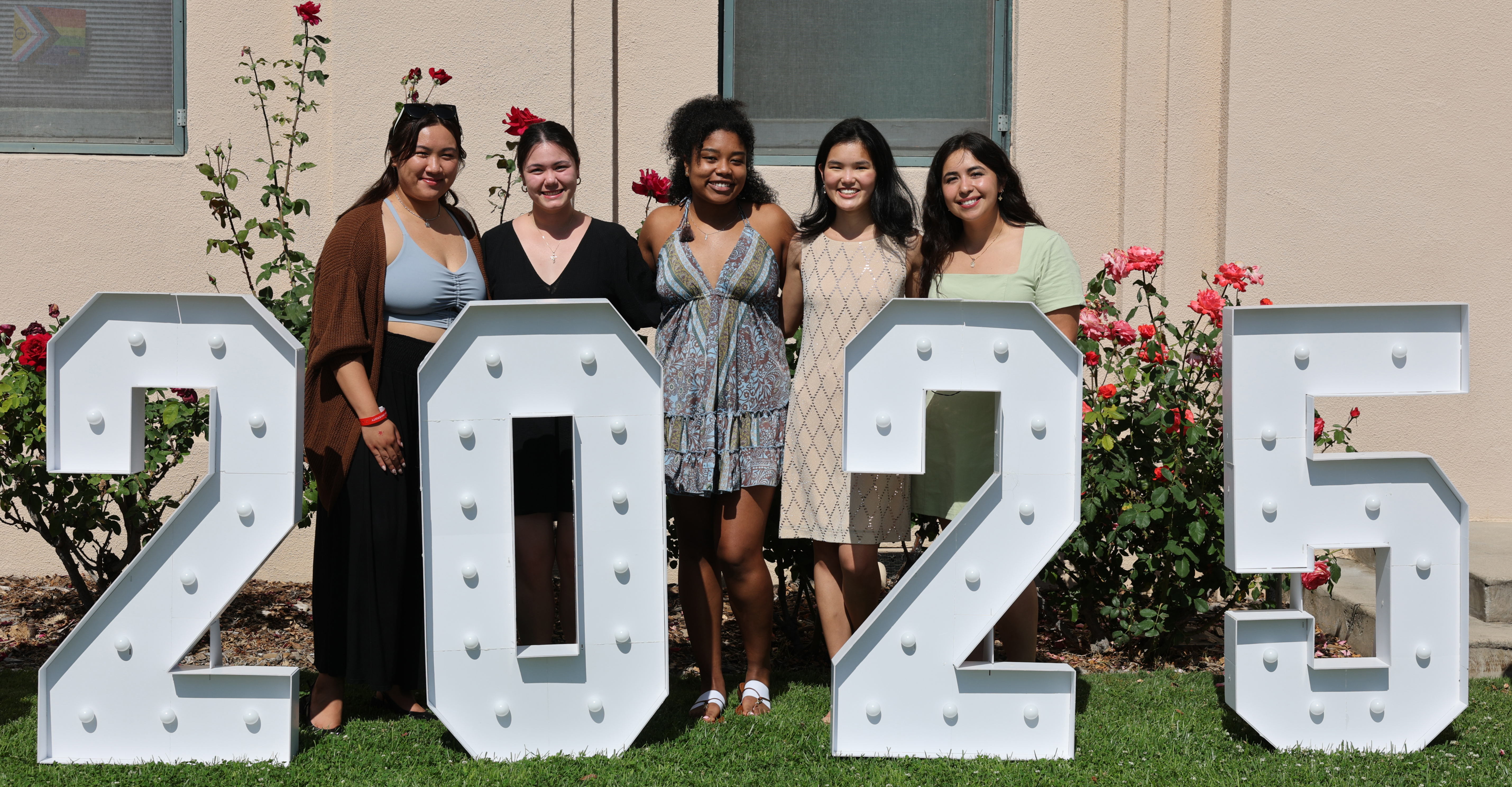 Seniors stand behind the 2025 letters at the Class of 2025 Senior Toast