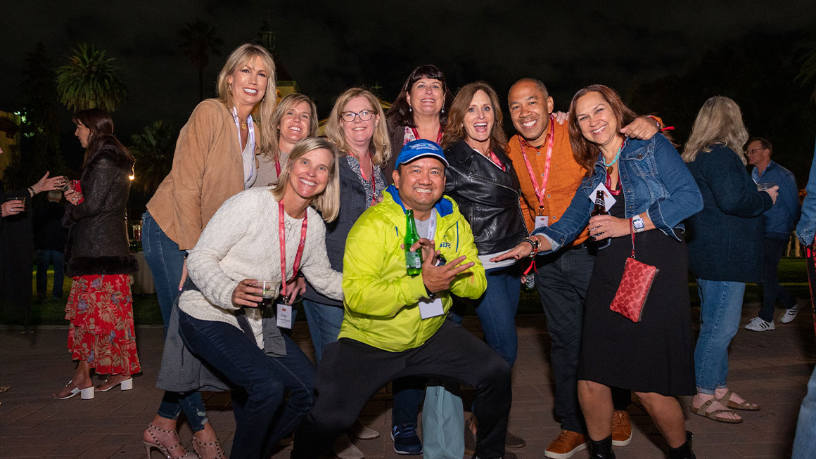 A large group of people smiling at the camera 
