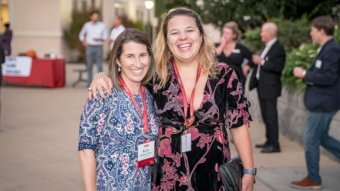 Two women smiling at the camera 