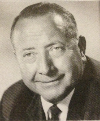 Black and white portrait of a man in a suit, titled A.P. Dutch Hamann HOF.