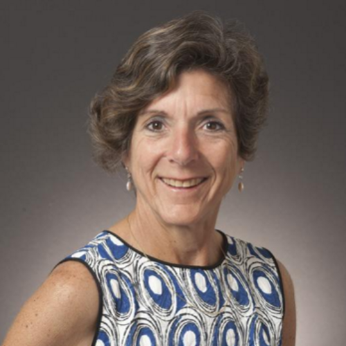 Woman in blue and white patterned dress smiling, titled Angela Robbiano - HOF Committee.
