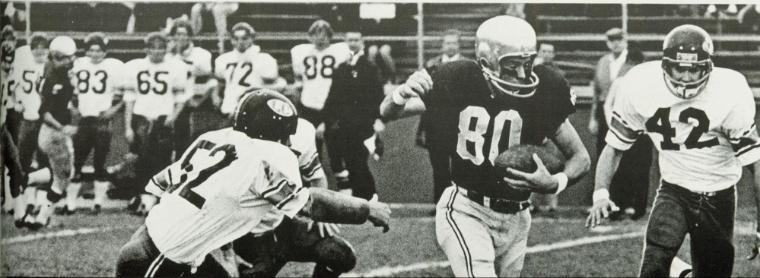A football player evades a tackle during a game.