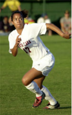 A soccer player running on a field during a game.