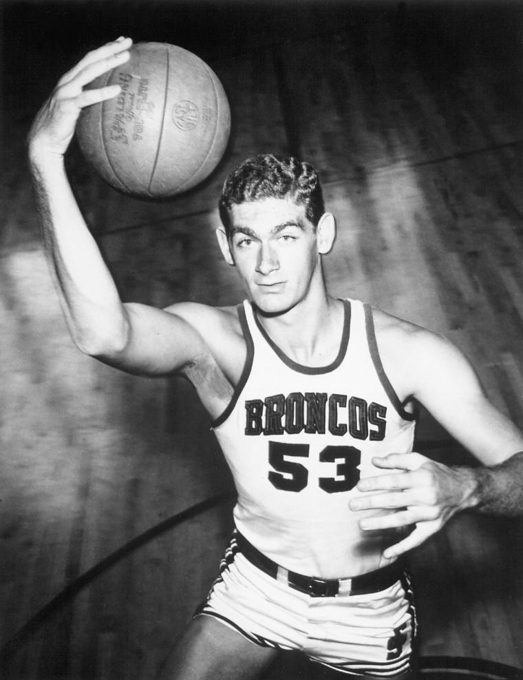 A vintage photo of a basketball player in a Mariners jersey.