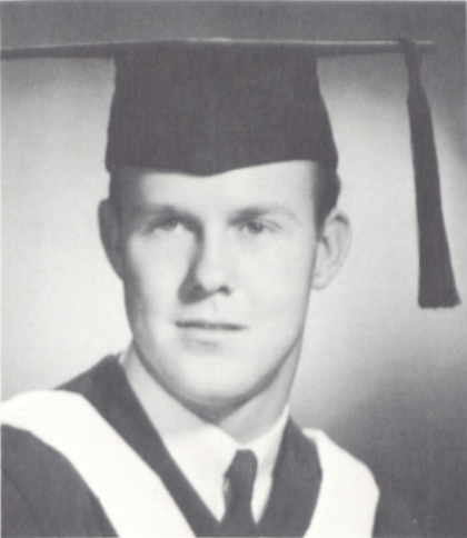 Black and white portrait of a man in graduation attire.