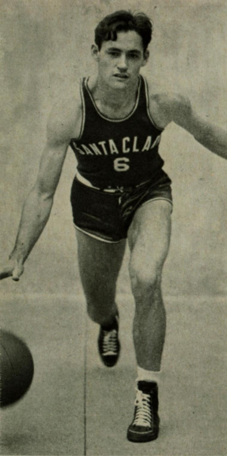 Black and white photo of a basketball player in action.