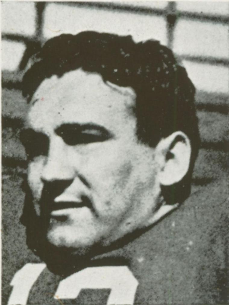 Black-and-white photo of a man wearing a sports jersey.