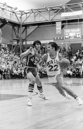 Black and white photo of two basketball players in action.