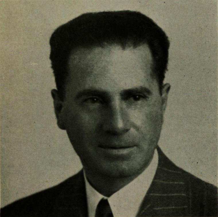 A black-and-white portrait of Edward Amaral wearing a suit and tie.