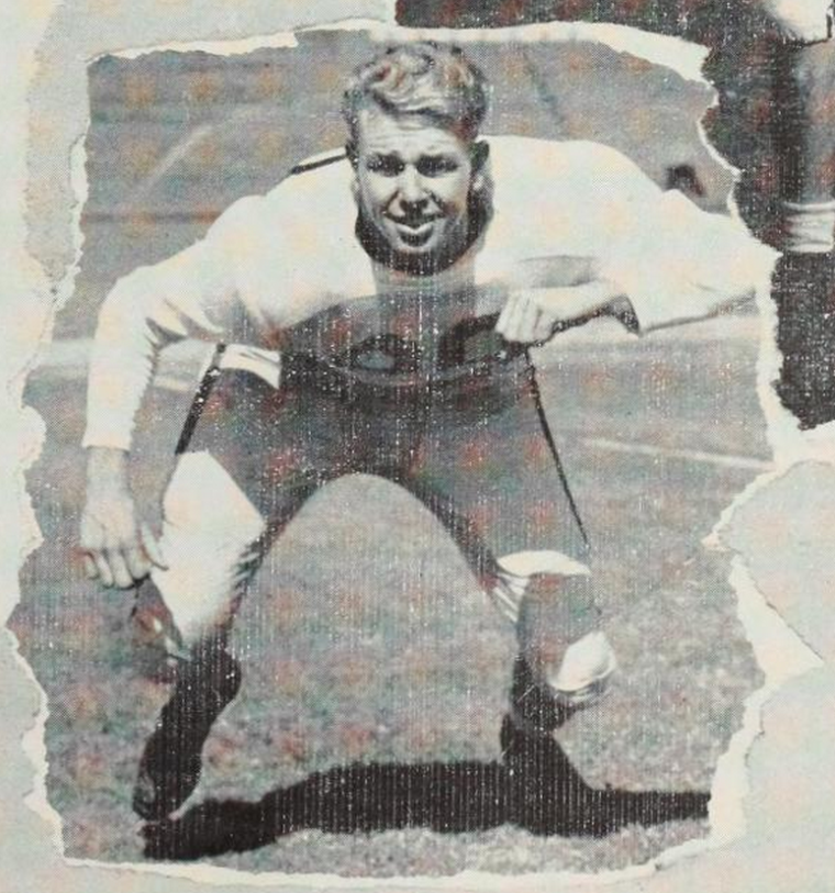 A football player crouching in a defensive stance.