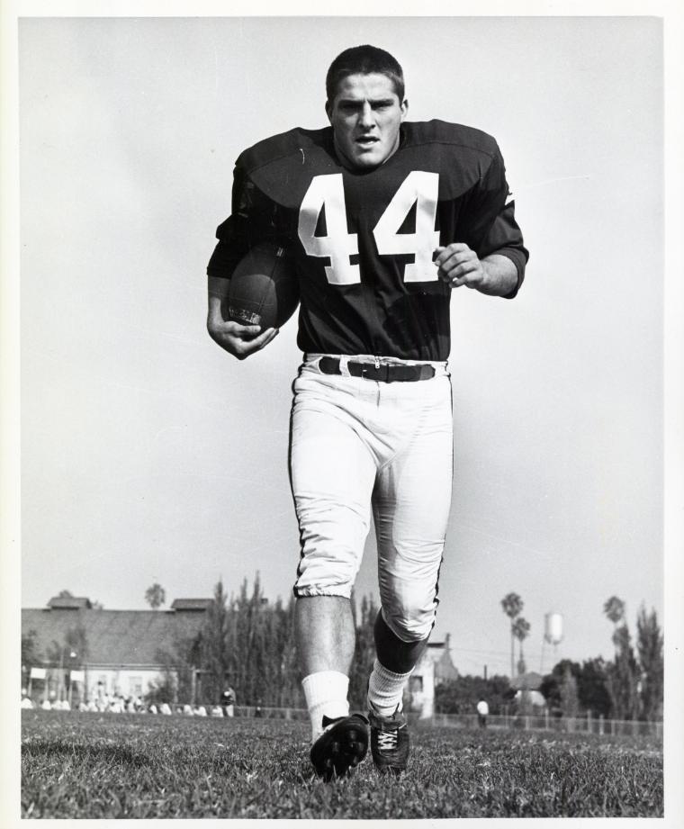 A football player holding a ball, wearing jersey number 44.