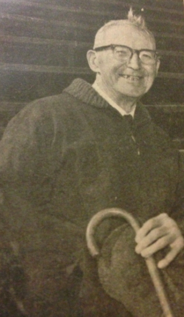 A person holding a cane and smiling, titled Frank Parducci HOF.