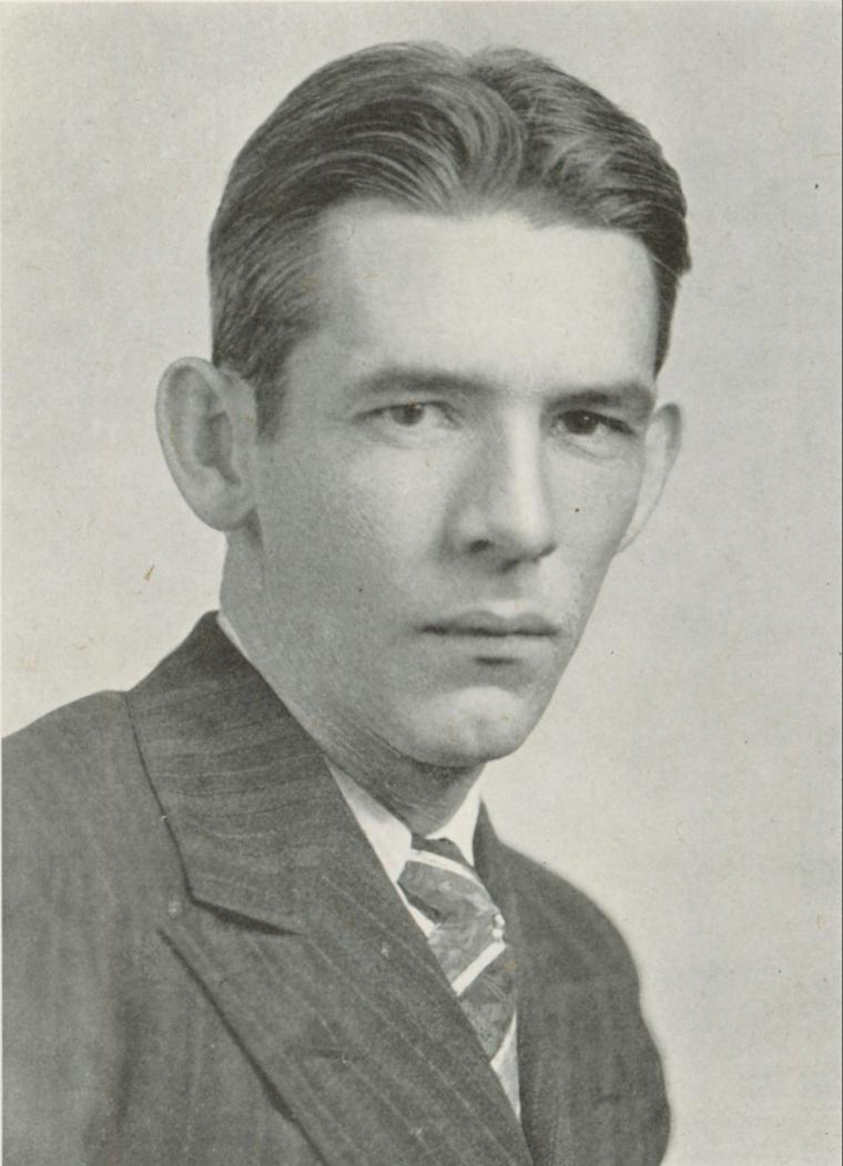 Black and white portrait of a man in a suit, titled Harlan Dykes HOF.