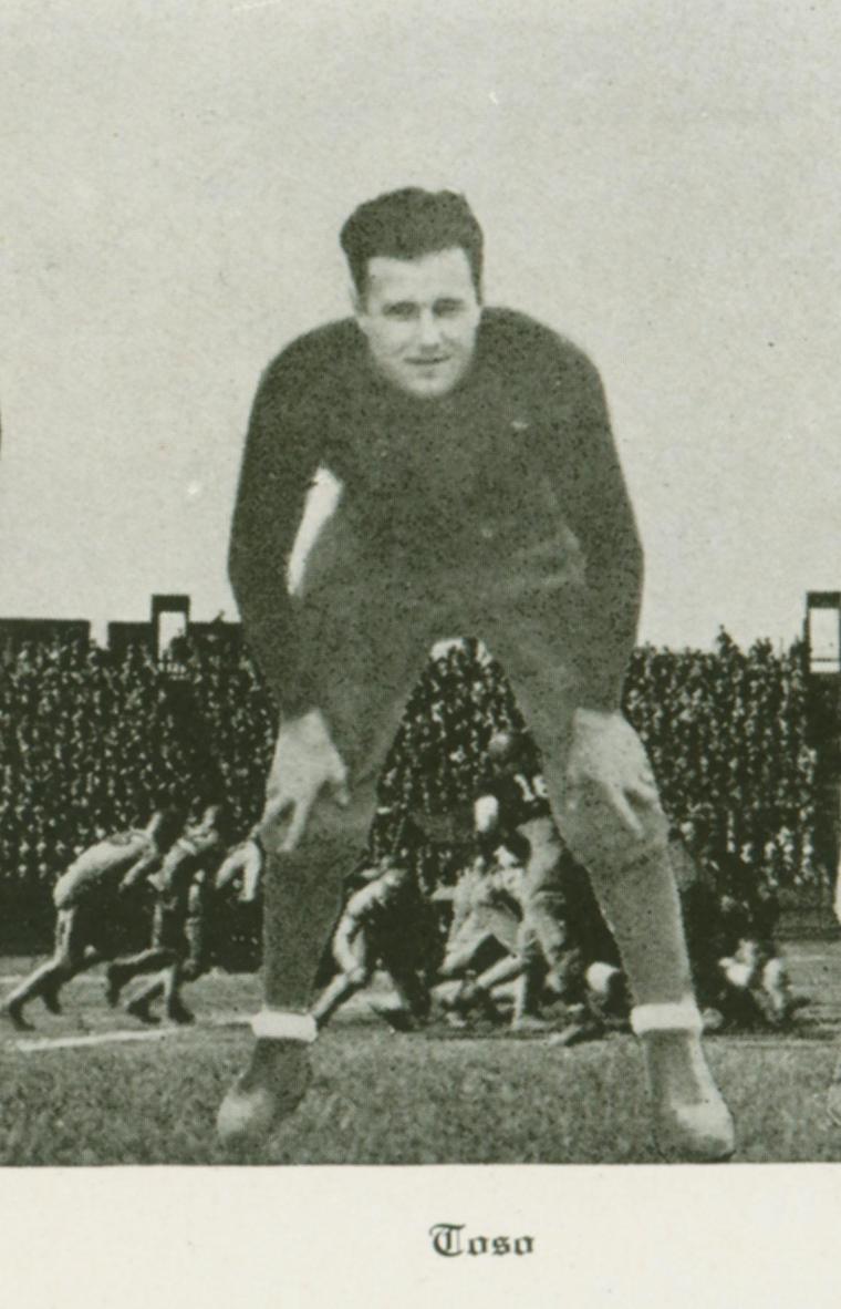 A football player crouched in a ready stance.