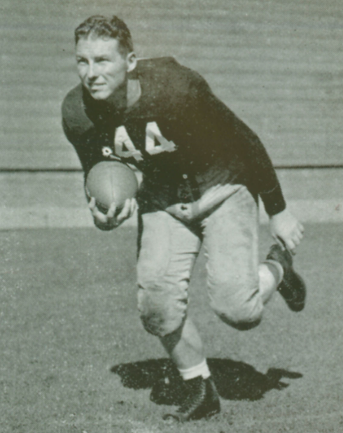 A football player running with the ball in uniform.