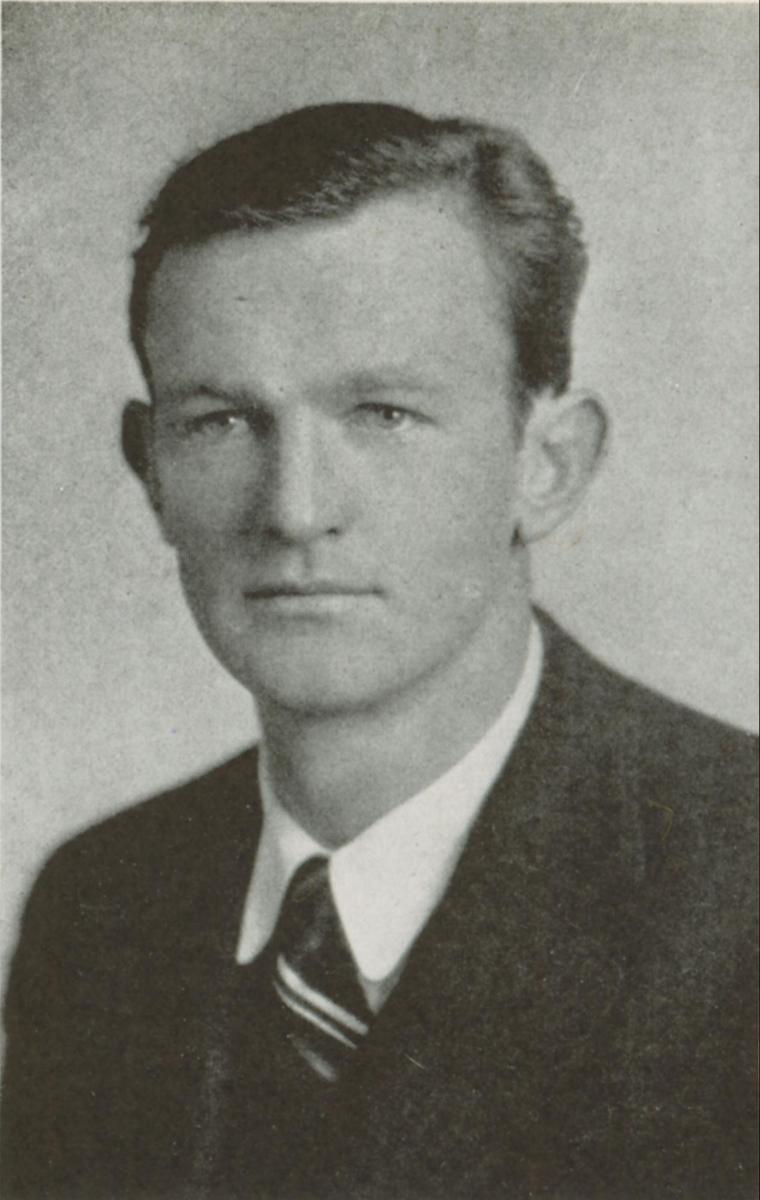 Black and white portrait of a man in a suit and tie.