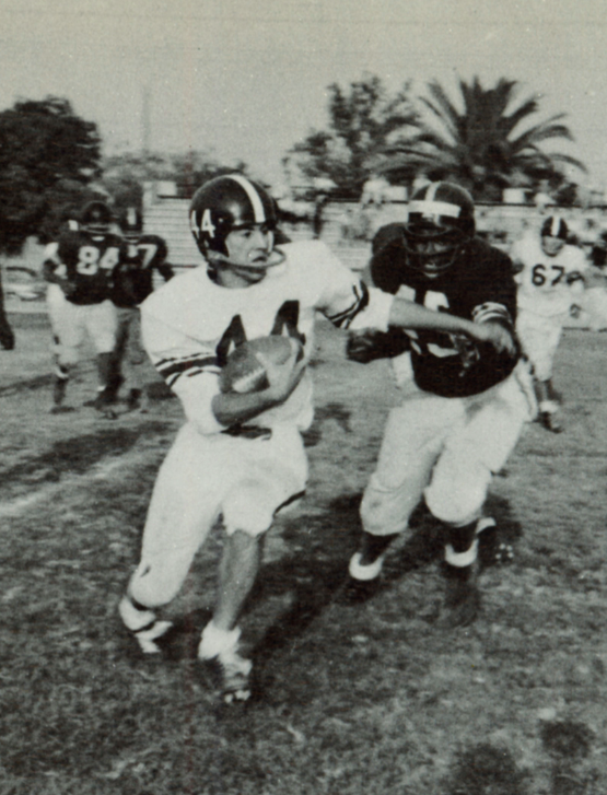 Black and white photo of a football game in progress.