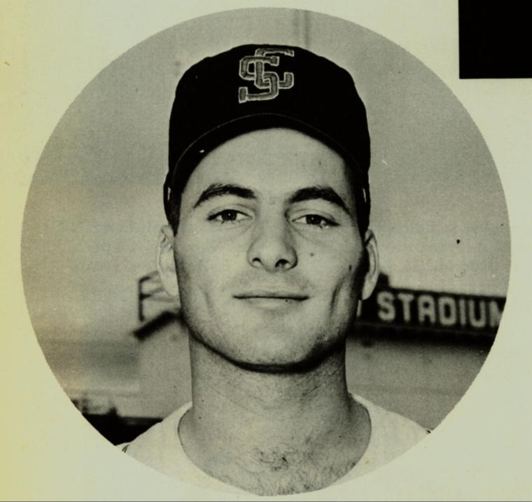 A black-and-white photo of John Boccabella in a baseball cap.