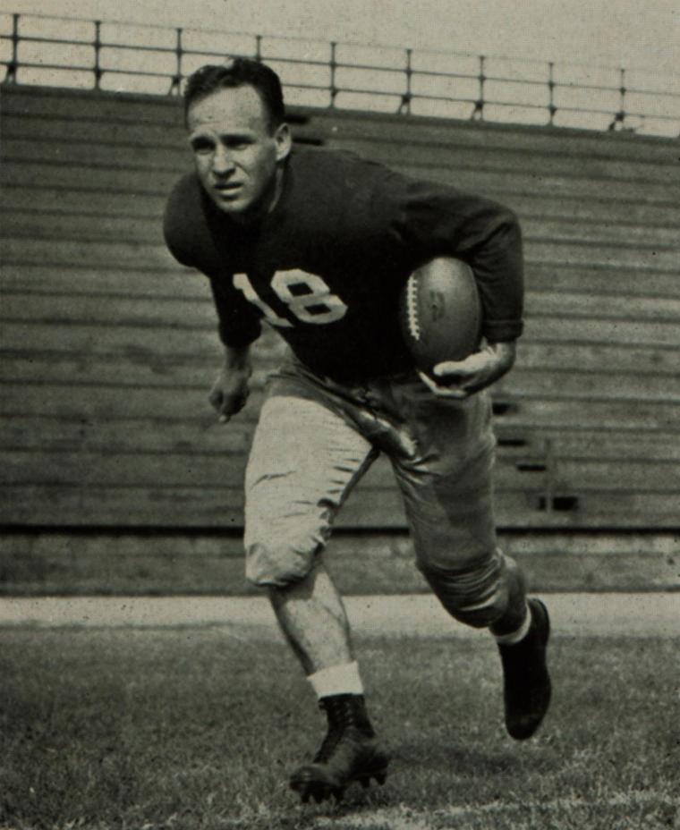 A football player from 1941 running with a football.