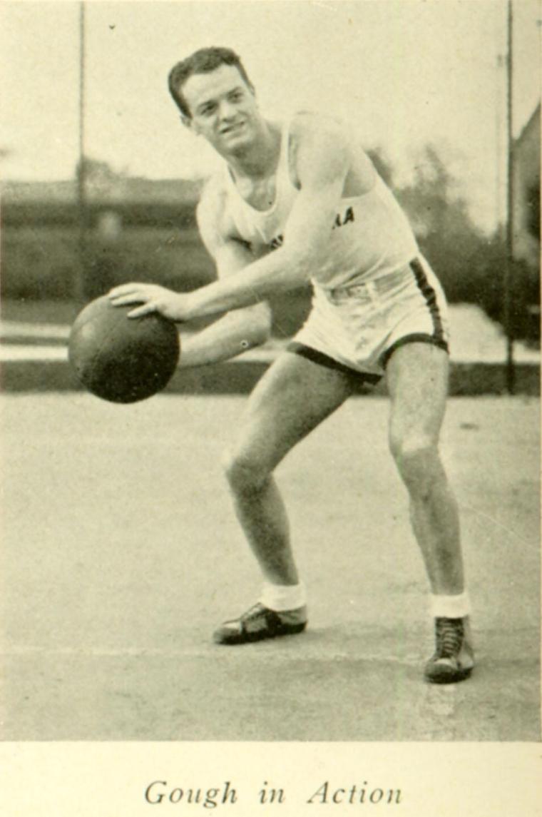 A man holding a basketball, ready to pass or shoot.