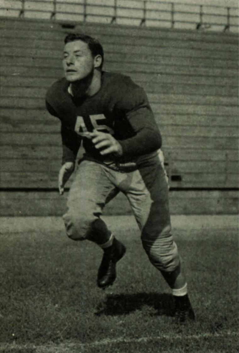 A football player in uniform running on a field, 1941.