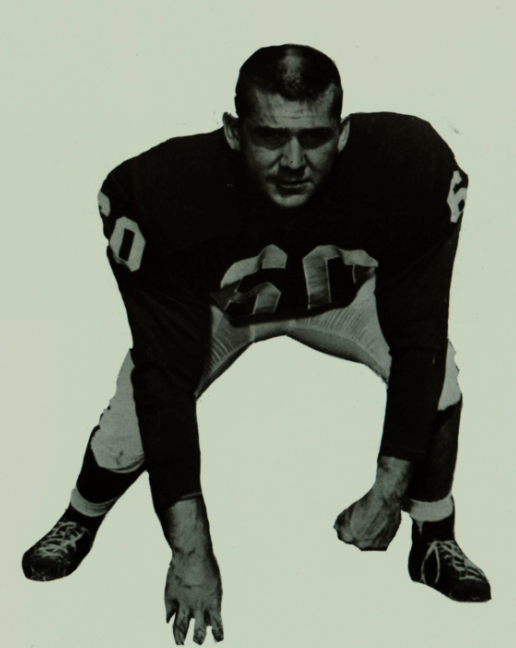 A football player in a crouched stance wearing the number 63 jersey.