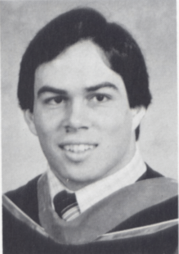 Black and white portrait of Michael Gonzales in academic attire.