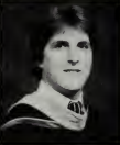 Black and white portrait of Michael Hewitt in graduation attire.