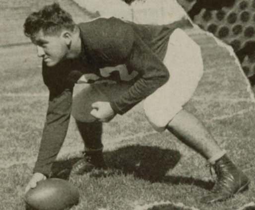 A football player in a crouched stance on a field.