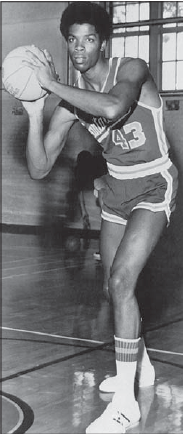 Black and white photo of a basketball player in action.